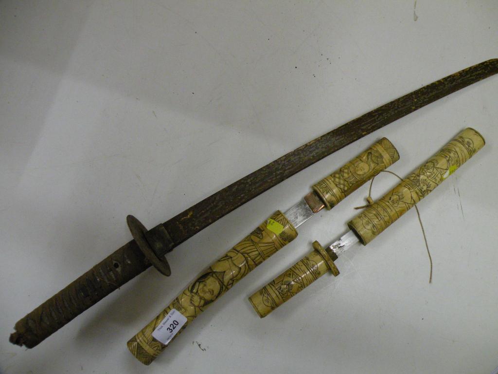 Appraisal: A Japanese samurai sword no scabbard and two Japanese bone