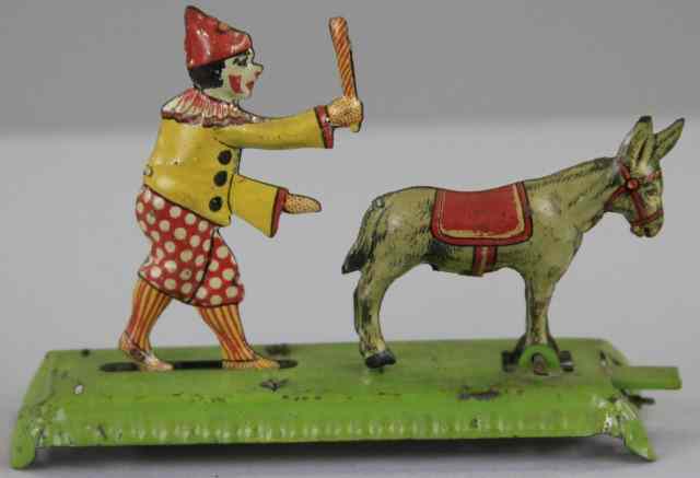 Appraisal: MEIER CLOWN HITTING DONKEY PENNY TOY Germany lithographed tin lever