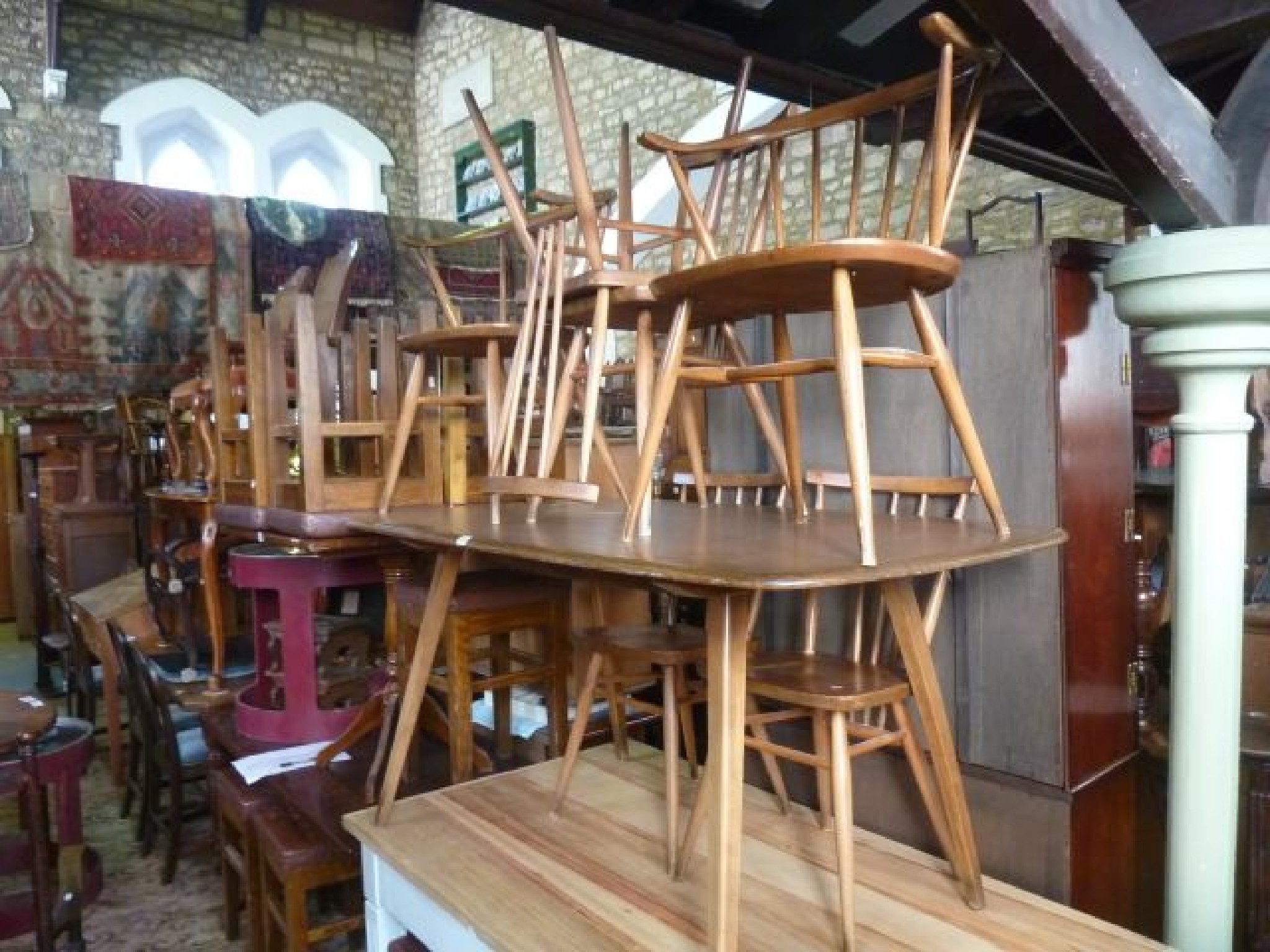 Appraisal: An Ercol rectangular dining table with elm top together with