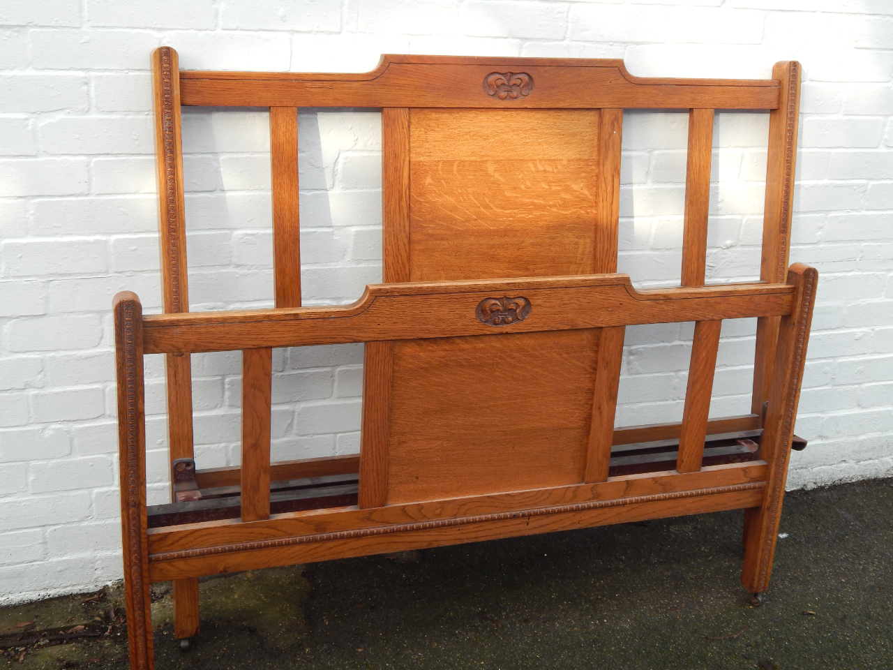 Appraisal: An Art Nouveau oak double bed Vono with side irons