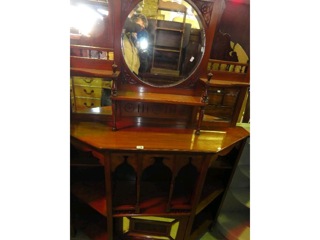 Appraisal: An Edwardian walnut breakfront chiffonier the lower section enclosed by