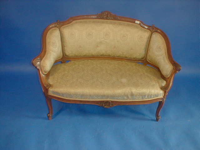 Appraisal: A Victorian carved walnut two seater sofa with carved and