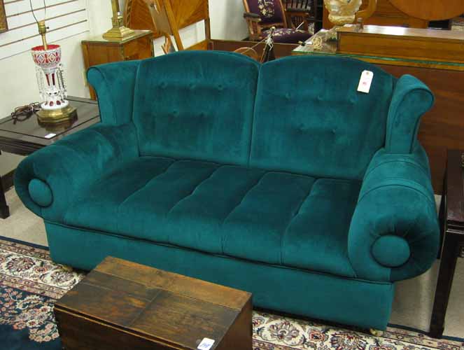 Appraisal: EMERALD GREEN WINGBACK LOVESEAT having buttoned back channel-tufted seat and