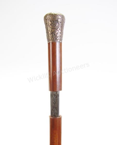 Appraisal: Fancy Sword Cane solid wood shaft silver embossed handle engraved