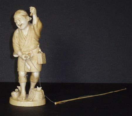 Appraisal: A Japanese ivory figure of a fisherman Meiji or Taisho