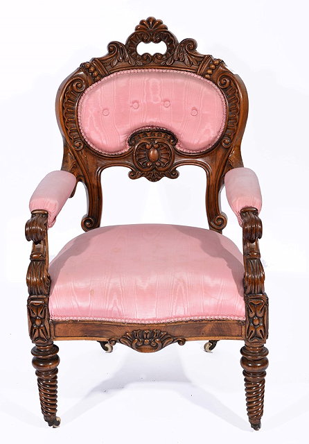 Appraisal: A VICTORIAN WALNUT ARMCHAIR with carved scroll decoration and turned