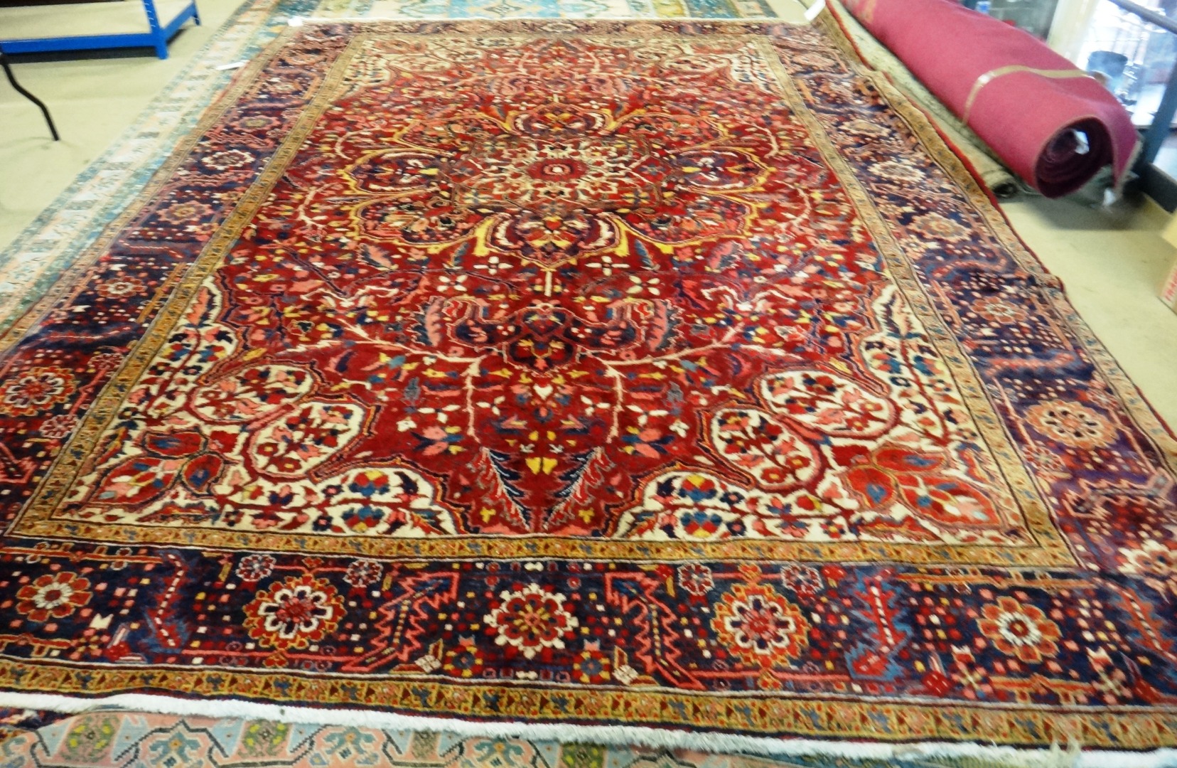 Appraisal: An Heriz carpet Persian the dark madder field with a