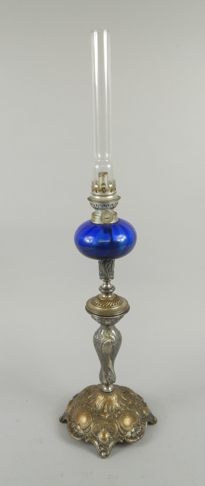 Appraisal: A WMF plated oil lamp with blue glass reservoir and