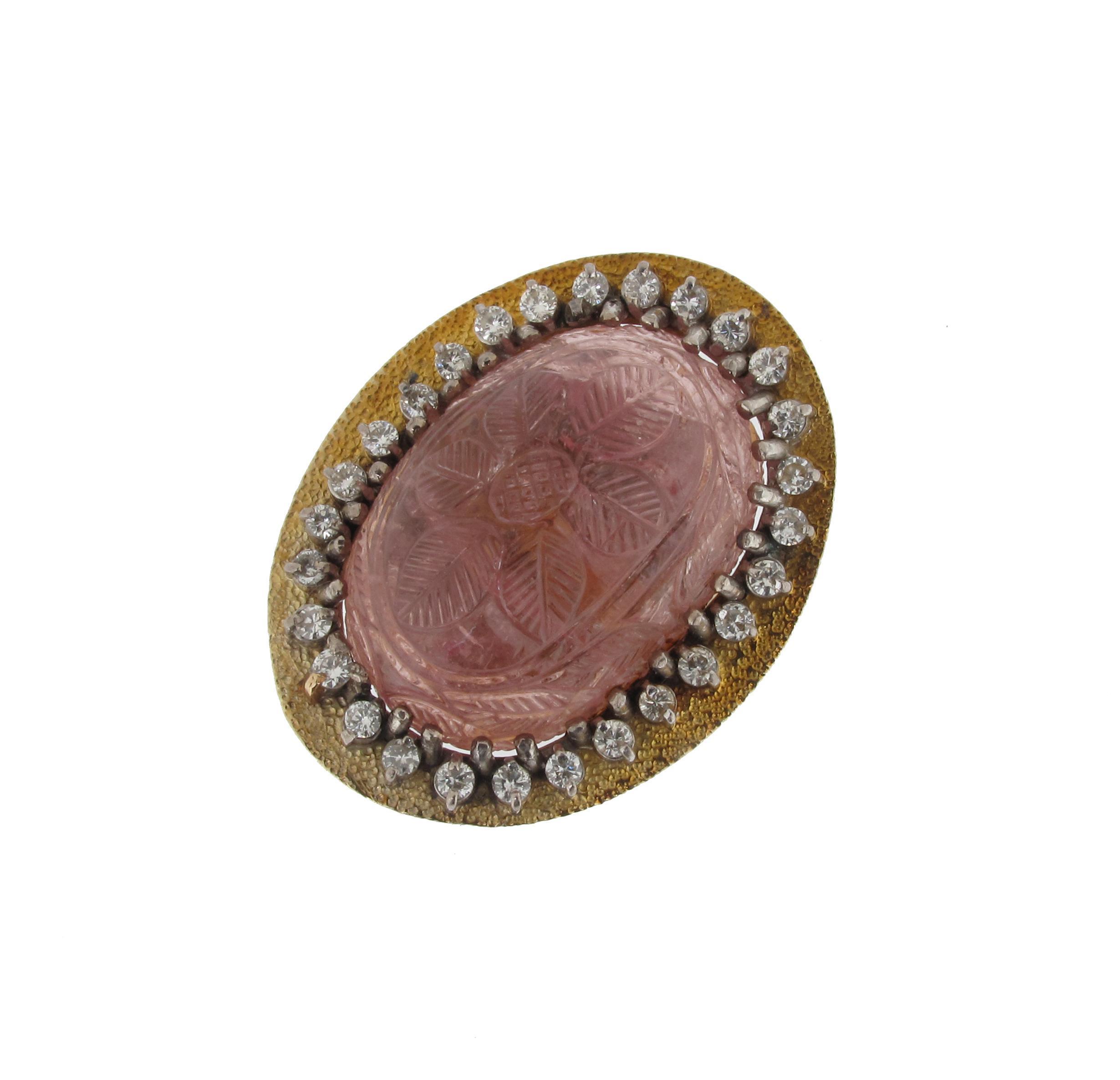 Appraisal: A gold ring mounted with a carved oval shaped pink