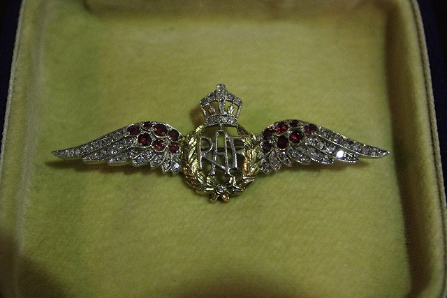 Appraisal: AN RAF WINGS BROOCH with ruby and diamond and chip