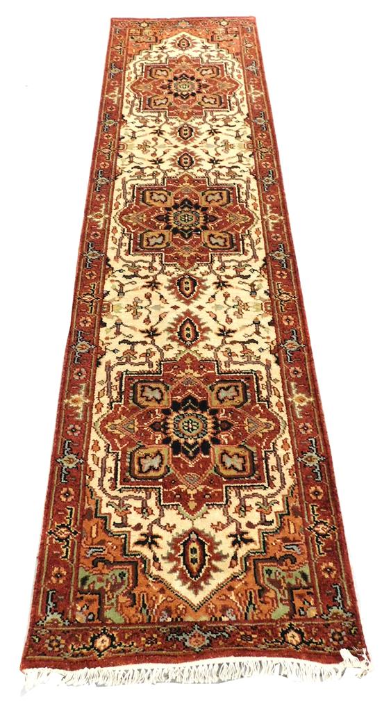 Appraisal: RUG Serapi runner cream field with three medallions coral border