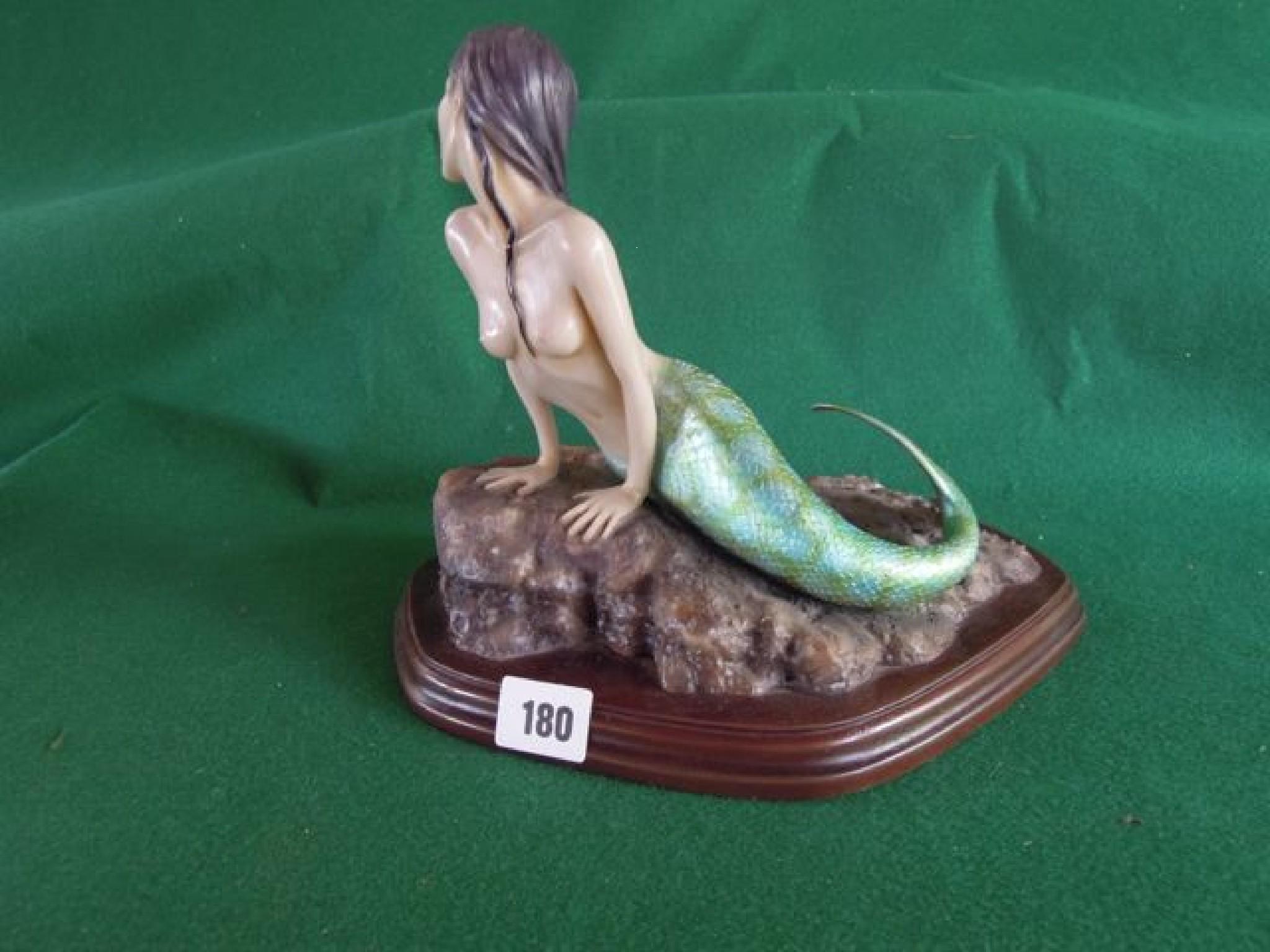 Appraisal: A fun resin model of a mermaid sat on a