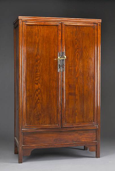 Appraisal: An elm wood two-door cabinet The upright rectangual cabinet wer