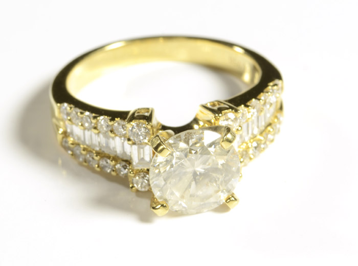 Appraisal: DIAMOND AND EIGHTEEN KARAT GOLD RING featuring around brilliant-cut center