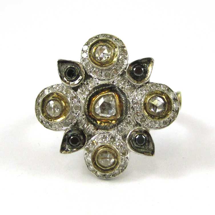 Appraisal: DIAMOND SILVER AND YELLOW GOLD RING The sterling silver and