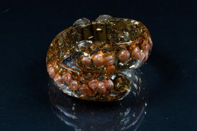 Appraisal: A vintage lucite hinged bangle embedded pink seashells and gold