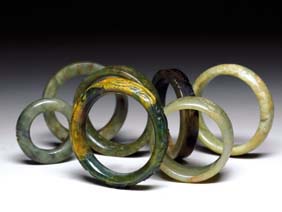 Appraisal: SEVEN JADE AND HARDSTONE BANGLES Seven Chinese carved jade and