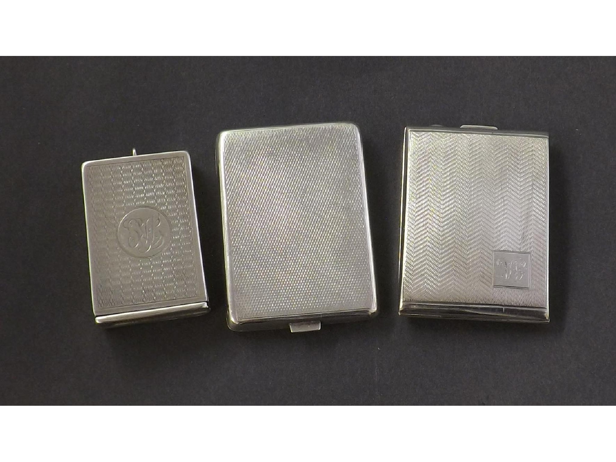 Appraisal: Three silver engine turned vesta cases each with hinged lid