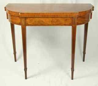 Appraisal: A th Century mahogany breakfront card table with rounded corners