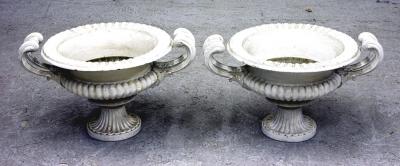 Appraisal: A PAIR OF VICTORIAN CAST IRON GARDEN URNS of semi