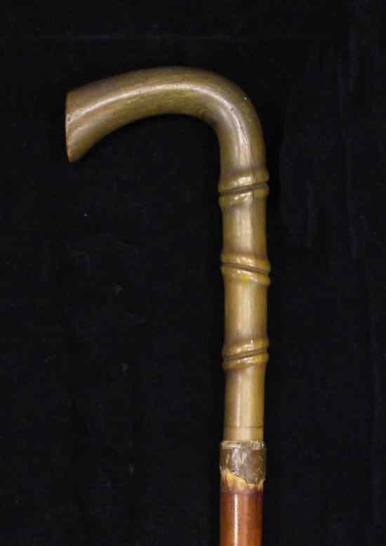 Appraisal: A rhinoceros horn handled malacca walking stick c the curved