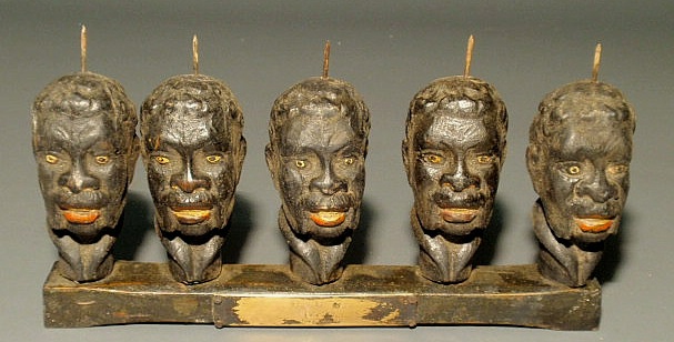 Appraisal: Five carved and painted African American heads mounted on a