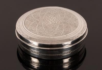 Appraisal: An Egyptian silver circular box with engraved decoration to the