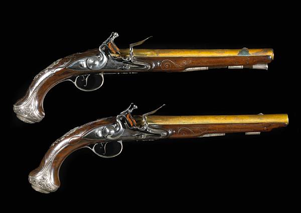 Appraisal: A pair of silver-mounted English flintlock pistols by John BumfordLondon