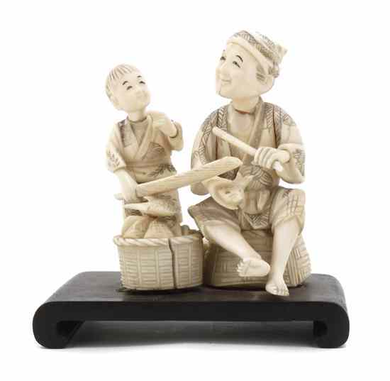 Appraisal: A Japanese Ivory Figure depicting a fisherman and a boy