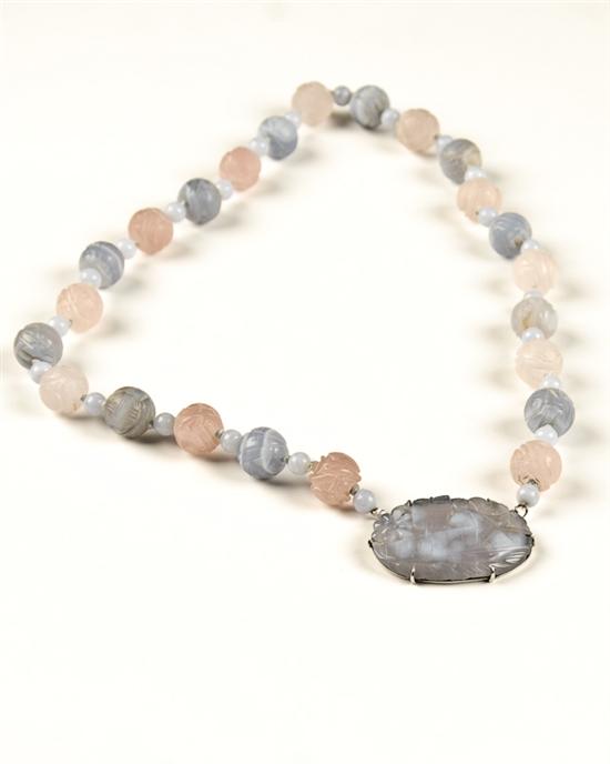 Appraisal: A Carved Rose and Blue Quartz Bead Necklace with an