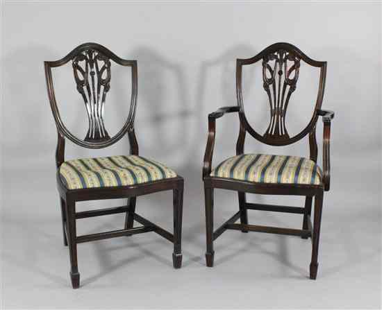 Appraisal: A set of twelve Hepplewhite design carved mahogany dining chairs