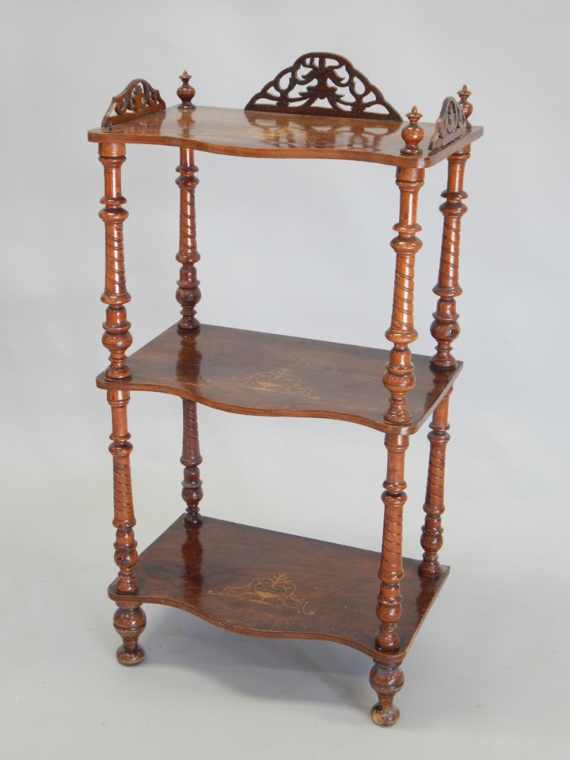 Appraisal: A Victorian walnut and marquetry three tier what not with