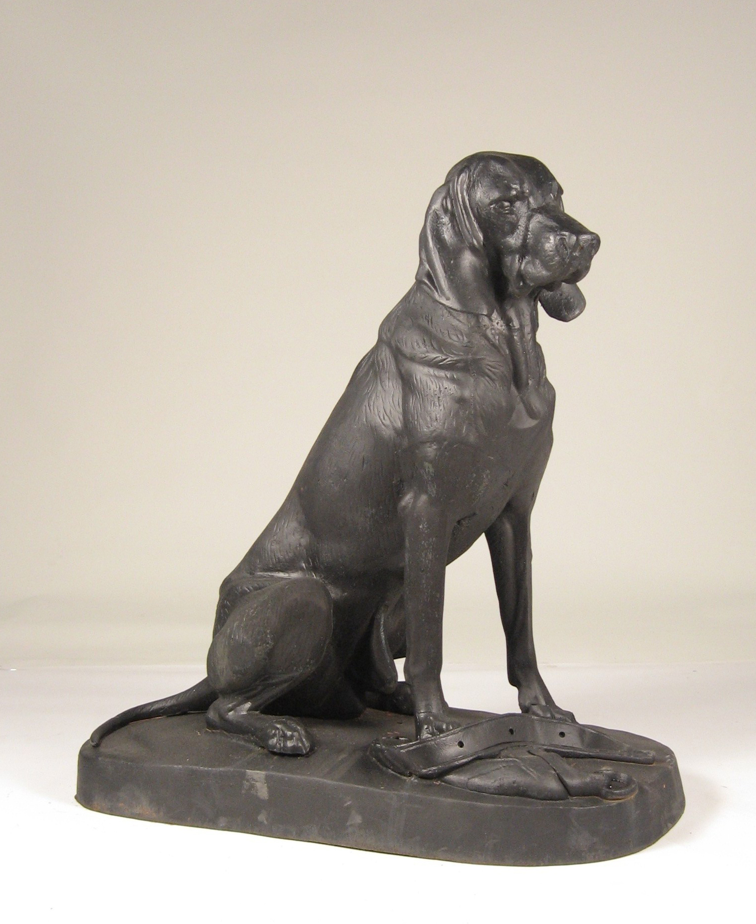 Appraisal: Painted cast metal figure of a seated hound The seated