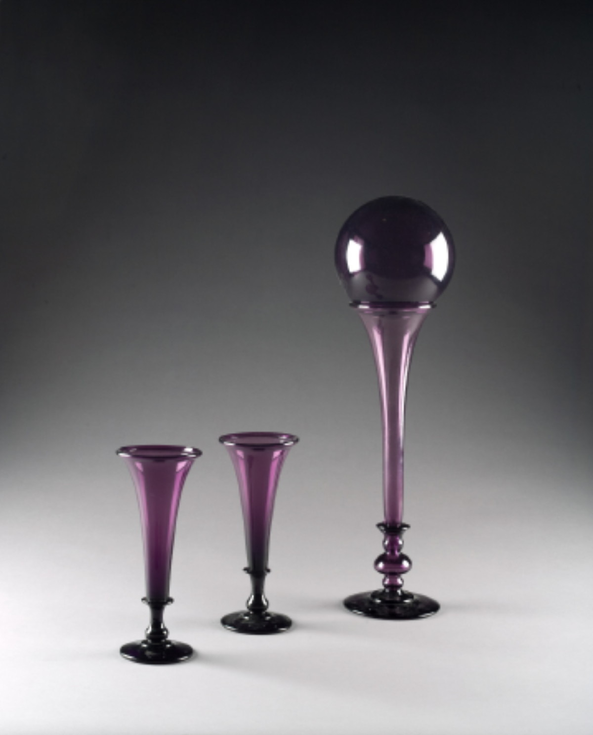 Appraisal: PAIR OF AMERICAN FREE-BLOWN DARK AMETHYST TRUMPET VASES PROBABLY NEW