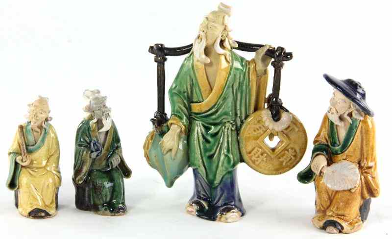 Appraisal: Four Chinese Mud Figures th century older gentlemen with polychrome