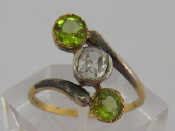 Appraisal: A diamond and peridot ring the central cushion cut approx