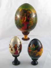 Appraisal: Three Russian wooden Easter eggs one with rural scene ht