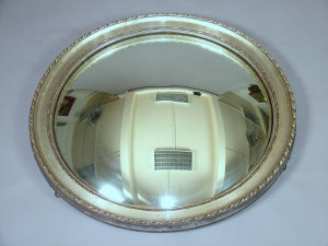 Appraisal: A large circular wall mirror circa 's the carved and