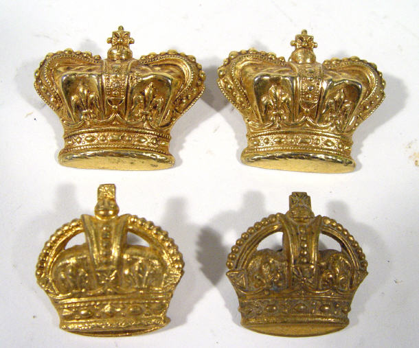 Appraisal: Four gilt metal armorial crown pin badges cm in length