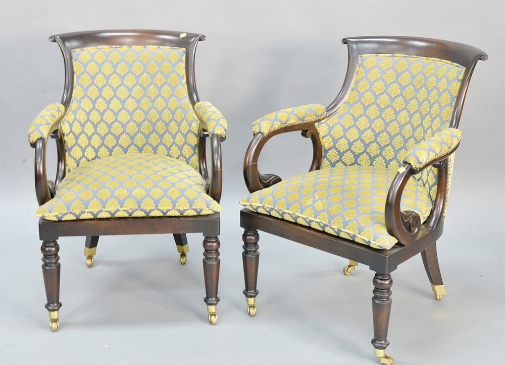 Appraisal: Pair of upholstered armchairs having brass casters Pair of upholstered