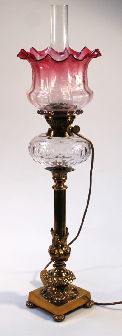 Appraisal: A Victorian brass column oil lamp with plain glass funnel