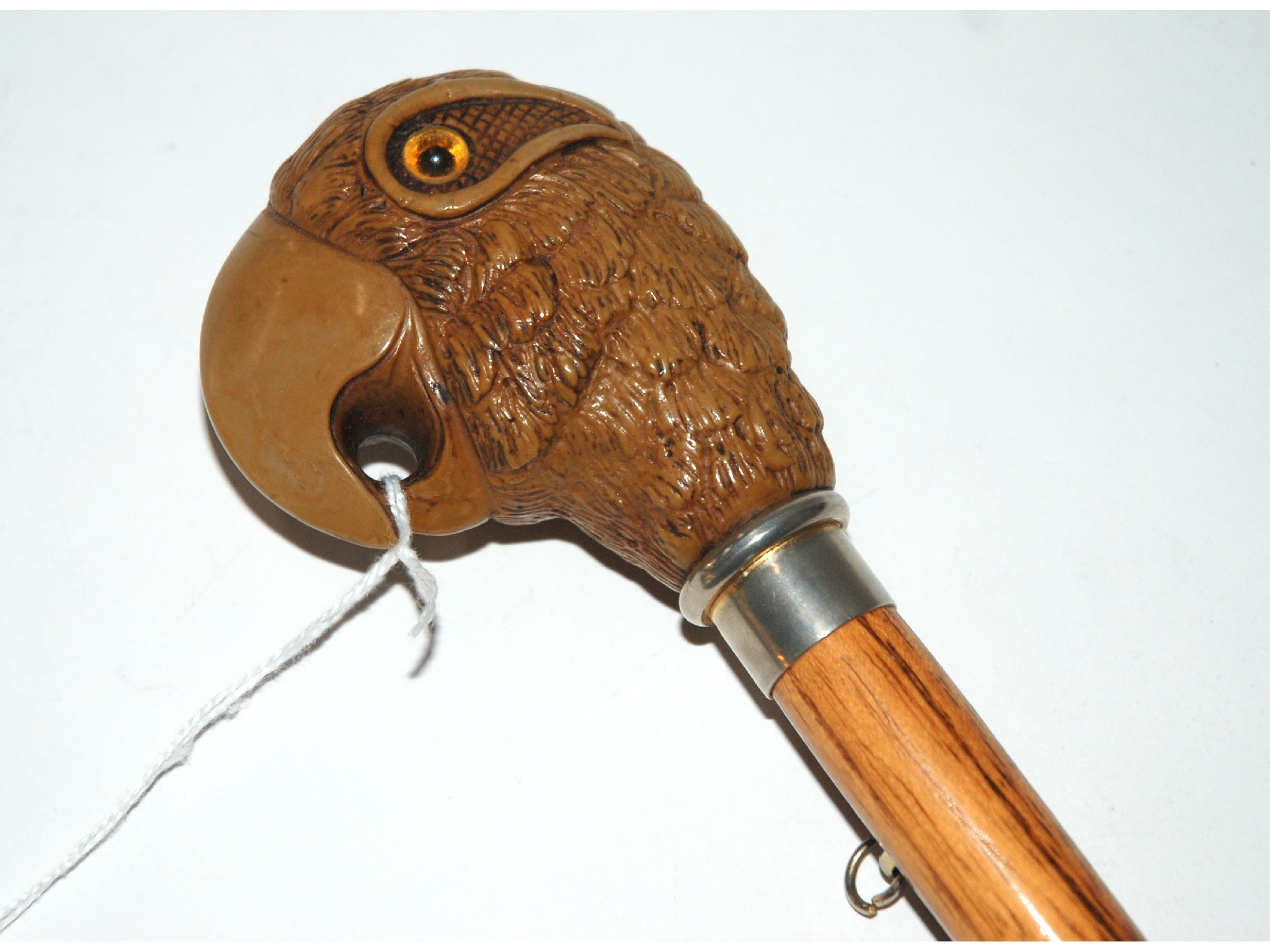 Appraisal: A walking stick handle the head modelled as a parrot's