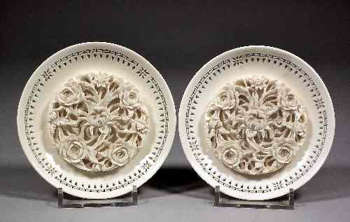 Appraisal: A pair of Chinese ivory circular dishes the centres with