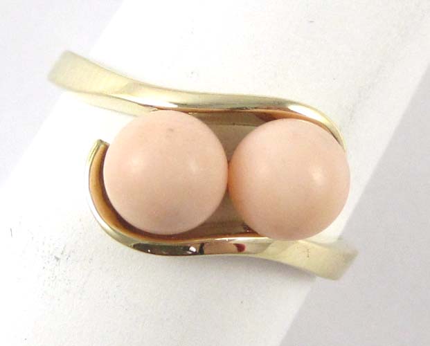 Appraisal: PINK CORAL AND FOURTEEN KARAT GOLD RING set with two