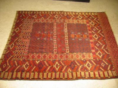 Appraisal: A HATCHLI RUG the red field divided into four panels