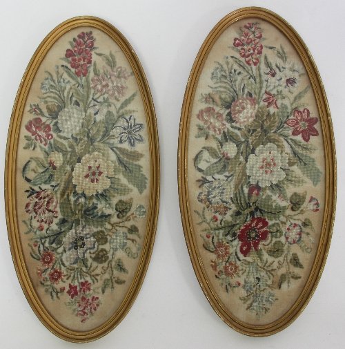 Appraisal: A pair of oval needlework panels depicting floral bouquets cm