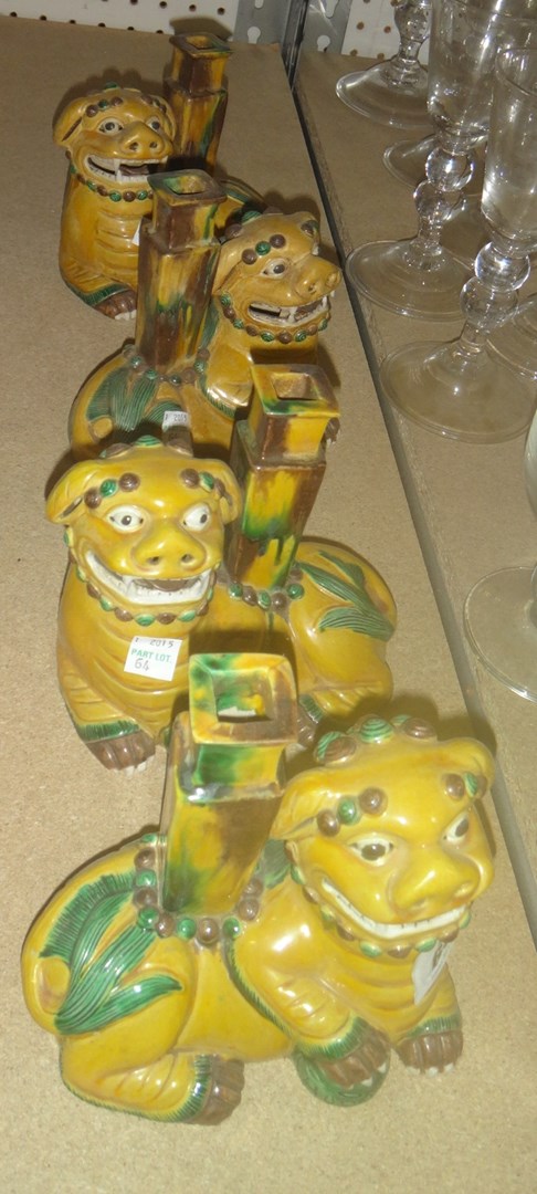 Appraisal: A group of four Oriental ceramic candlesticks formed as lion