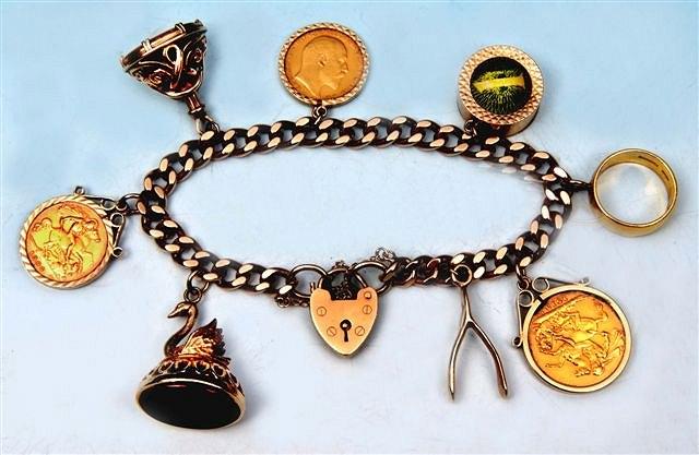 Appraisal: A gold curb link charm bracelet set with a sovereign