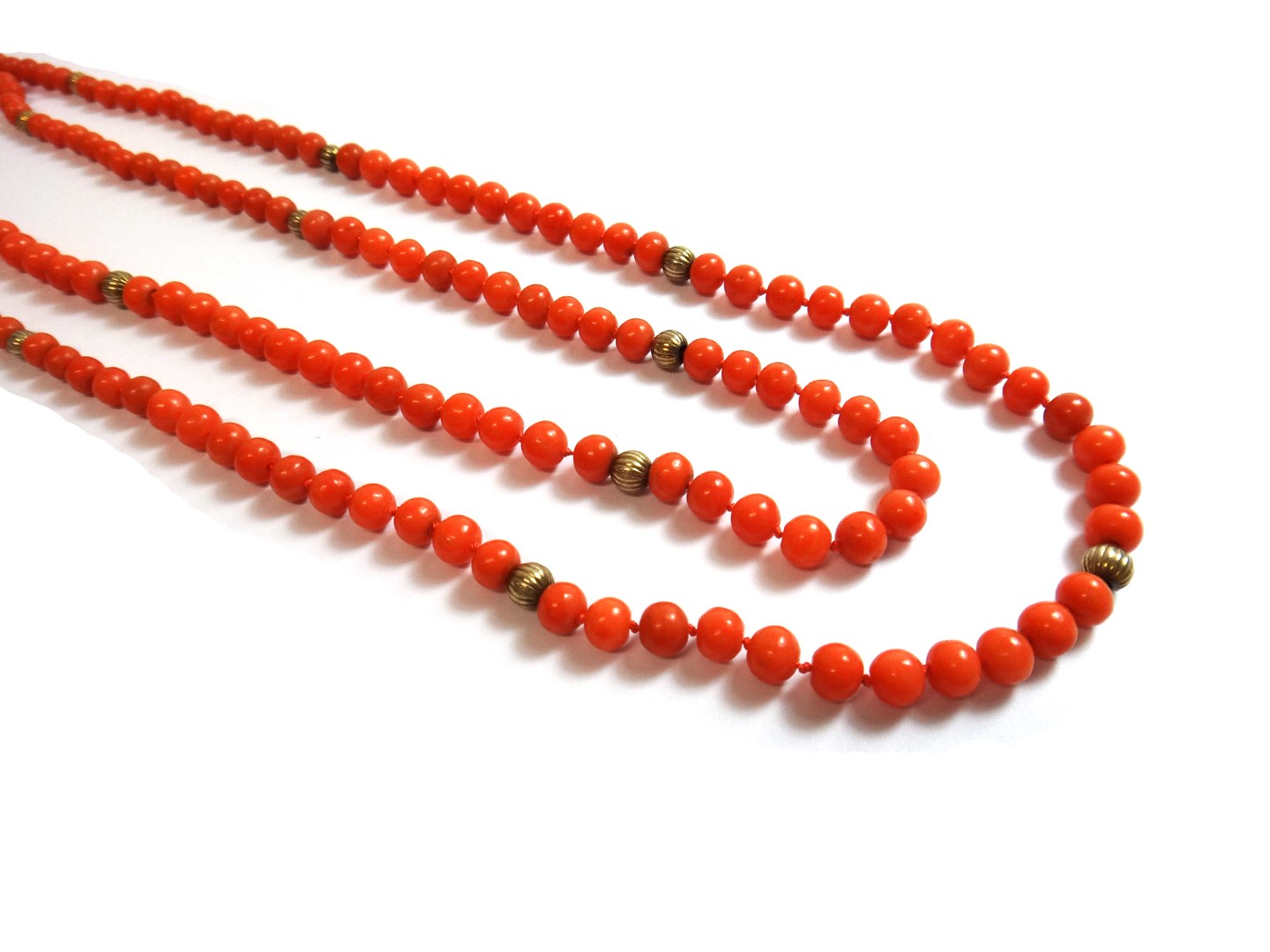 Appraisal: A two row necklace of coral beads on a gold