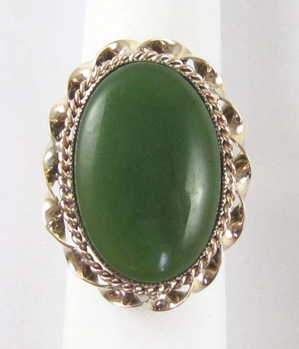 Appraisal: GREEN JADE AND FOURTEEN KARAT GOLD RING Framed in yellow